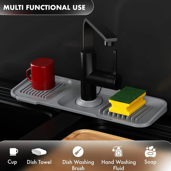 A silicone sink splash guard and drip catcher tray with a black faucet and various kitchen tools.