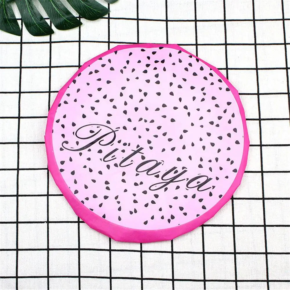 Pink reusable fruit shower cap with a black speckled pattern and the word Pitaya written on it.