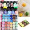 A collection of 18 colors of concentrated liquid candle dye bottles and finished yellow and green candles.