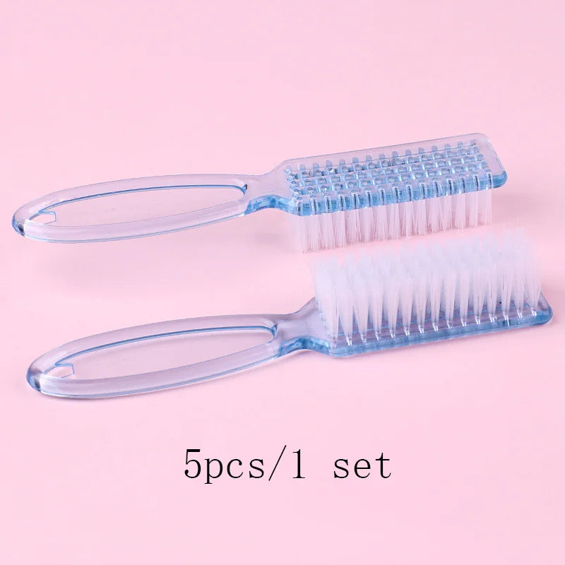 A set of five clear plastic brushes for nail art and dust cleaning displayed on a pink background.