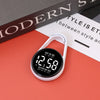 A white digital LED hanging pocket watch displaying 12:58 on a red surface.