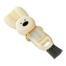 A beige silicone cleaning brush set with a bear head and a bottle cleaning attachment.