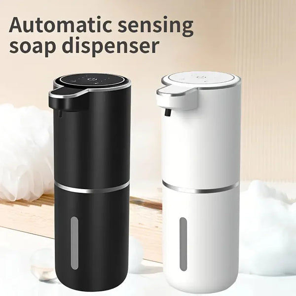 A black and white automatic sensing soap dispenser is shown standing on a wooden surface.