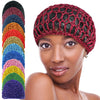 A model wears a hand-crocheted mesh hair net cap in a vibrant gradient of colors.
