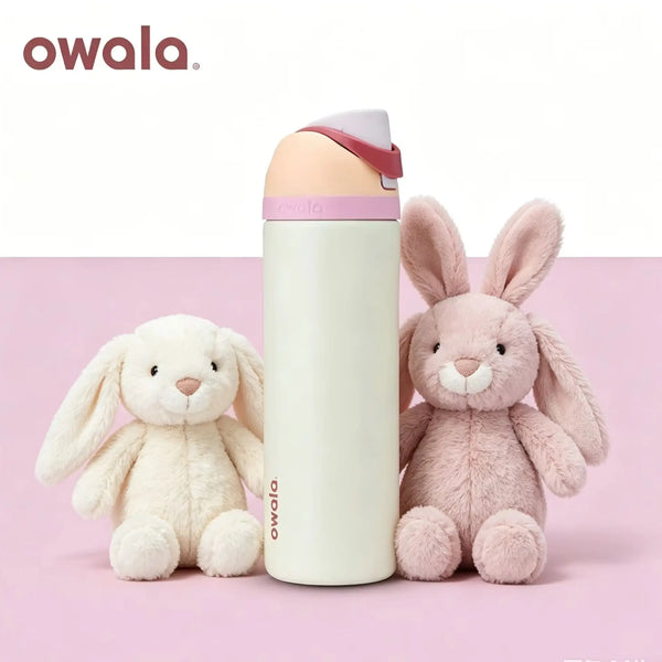 A pink owala insulated water bottle with a straw and a fluffy pink rabbit toy are displayed on a pink background.