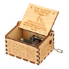 A vintage engraved wooden music box with a lid featuring a message to a daughter