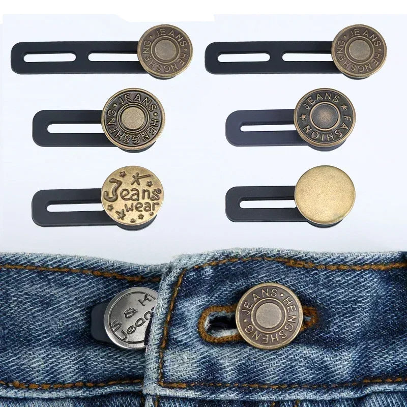 A set of adjustable button extenders in gold and brass colors shown against a denim fabric.