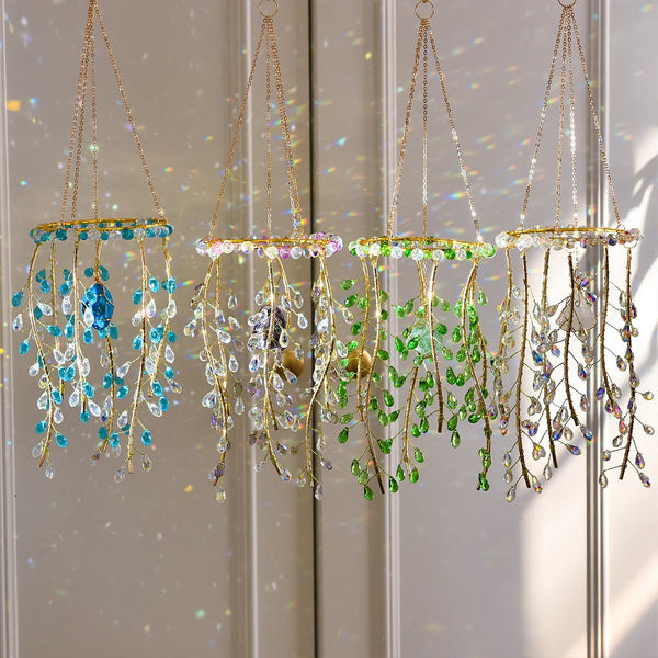 A collection of hanging crystal wind chimes and suncatchers featuring various colored glass and metal elements.