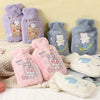 A collection of purple, pink, and gray plush cartoon hot water bottles featuring bears and bubbles.