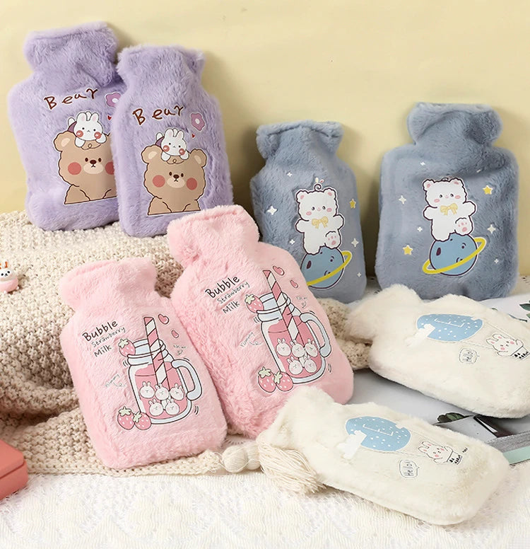 A collection of purple, pink, and gray plush cartoon hot water bottles featuring bears and bubbles.