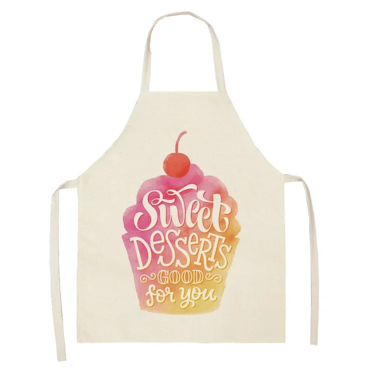 A light yellow apron with a pink swirl dessert design that reads Sweet Desserts good for you
