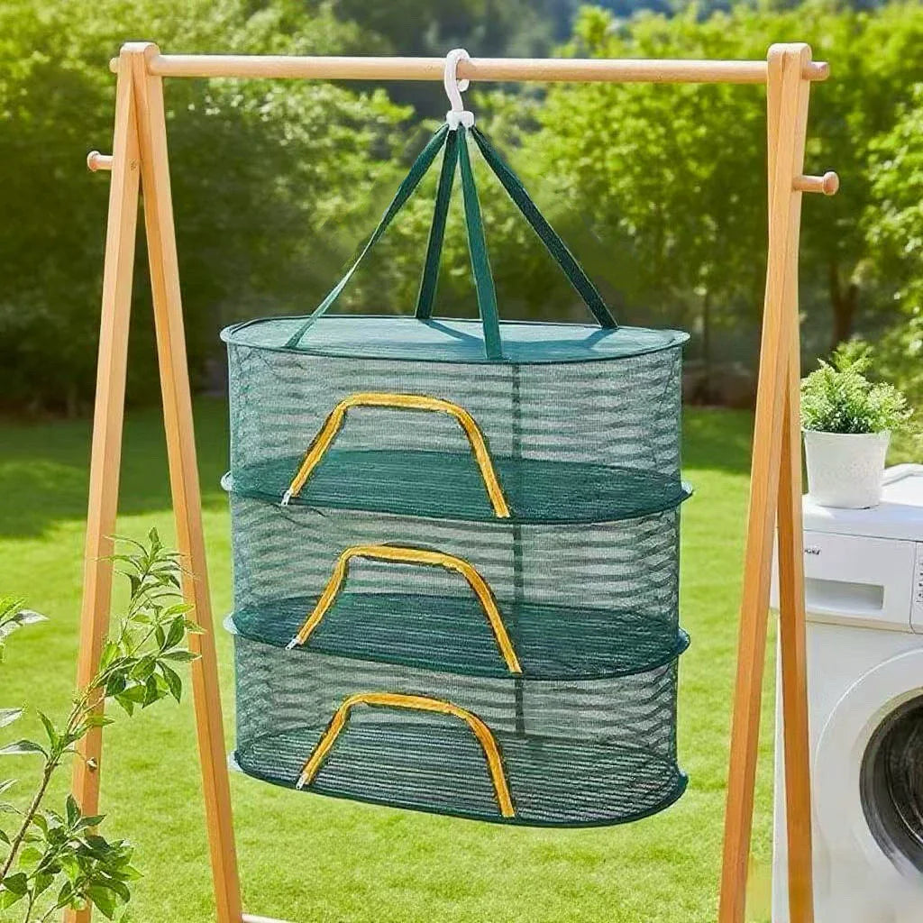 A portable folding drying rack made of wood holds three stacked mesh baskets for drying fruits and fish outdoors.