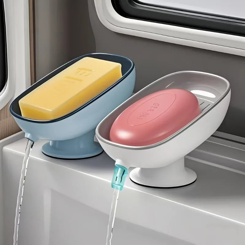 A pink and blue countertop soap dish with a suction cup base is shown dispensing soap into a yellow bar.