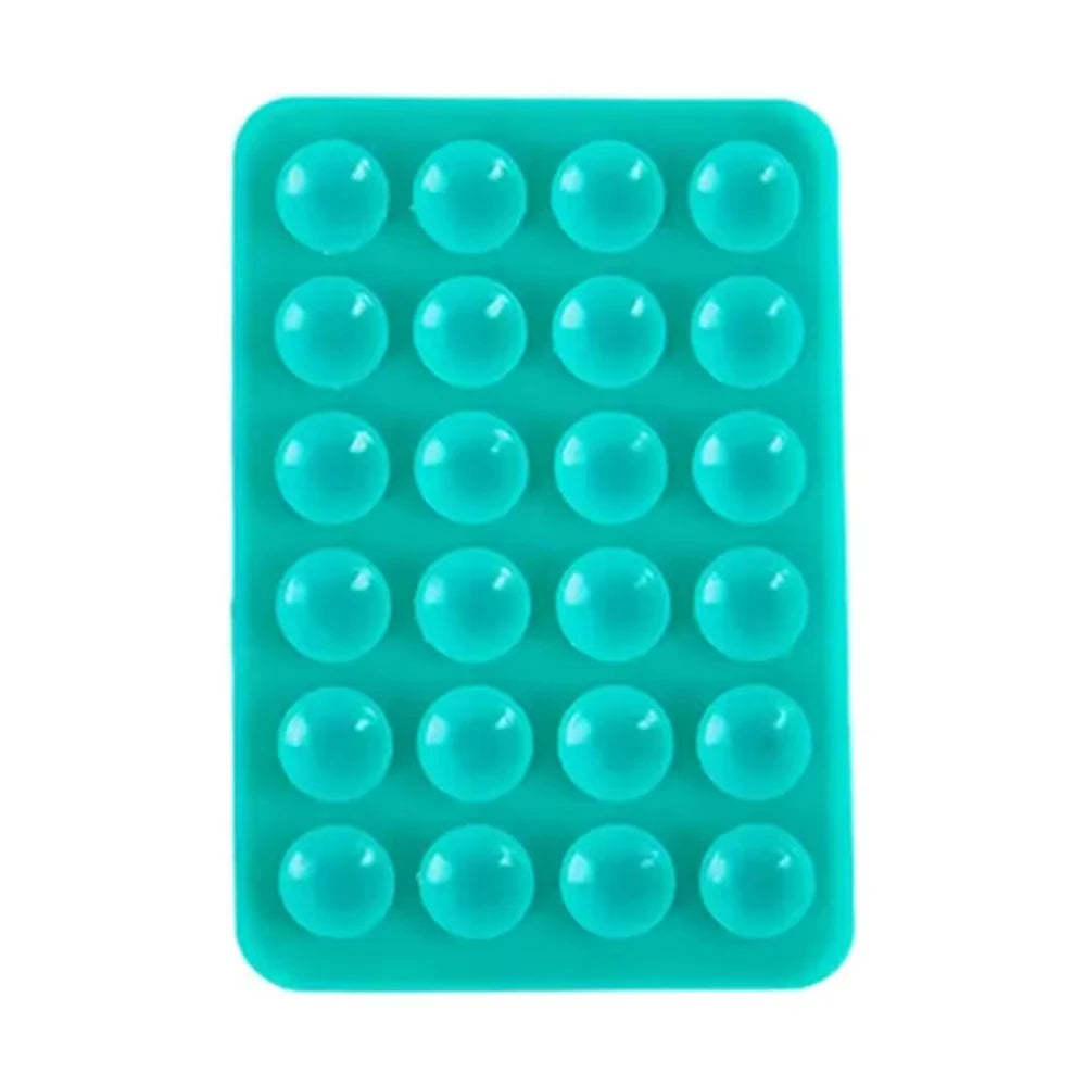A teal silicone suction cup phone stand with multiple circular holes for hands-free viewing.