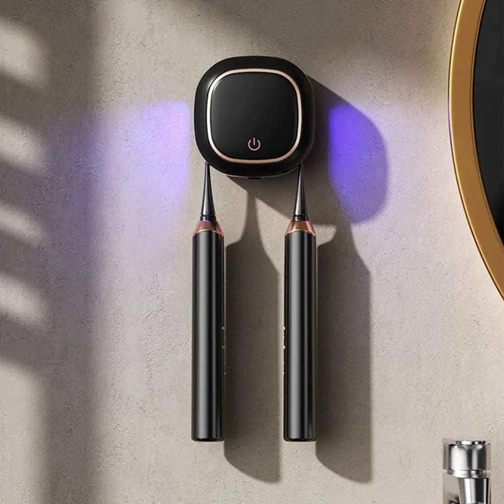 A portable UV electric toothbrush cleaner with a black base and two slender cleaning rods mounted on a wall.