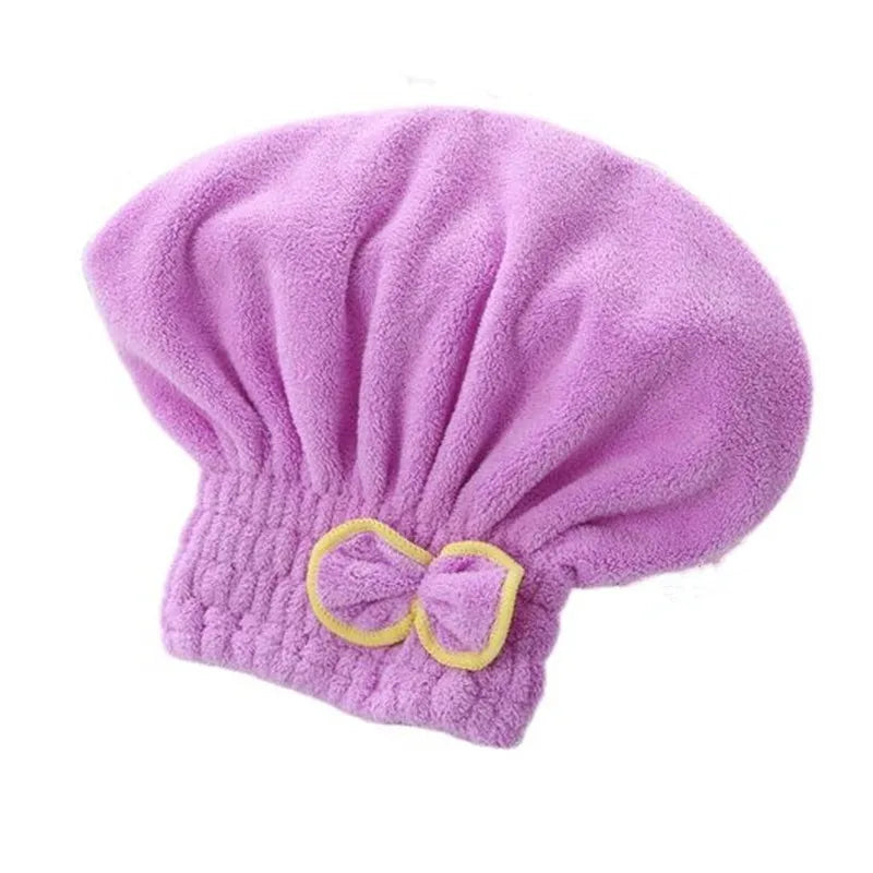 A purple microfiber hair drying towel cap with a yellow bow.