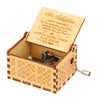 A vintage engraved wooden music box with a lid open showing an inscription for a daughter