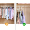 A close-up view of a foldable multi-hole space-saving laundry drying rack with various colored shirts hanging inside.
