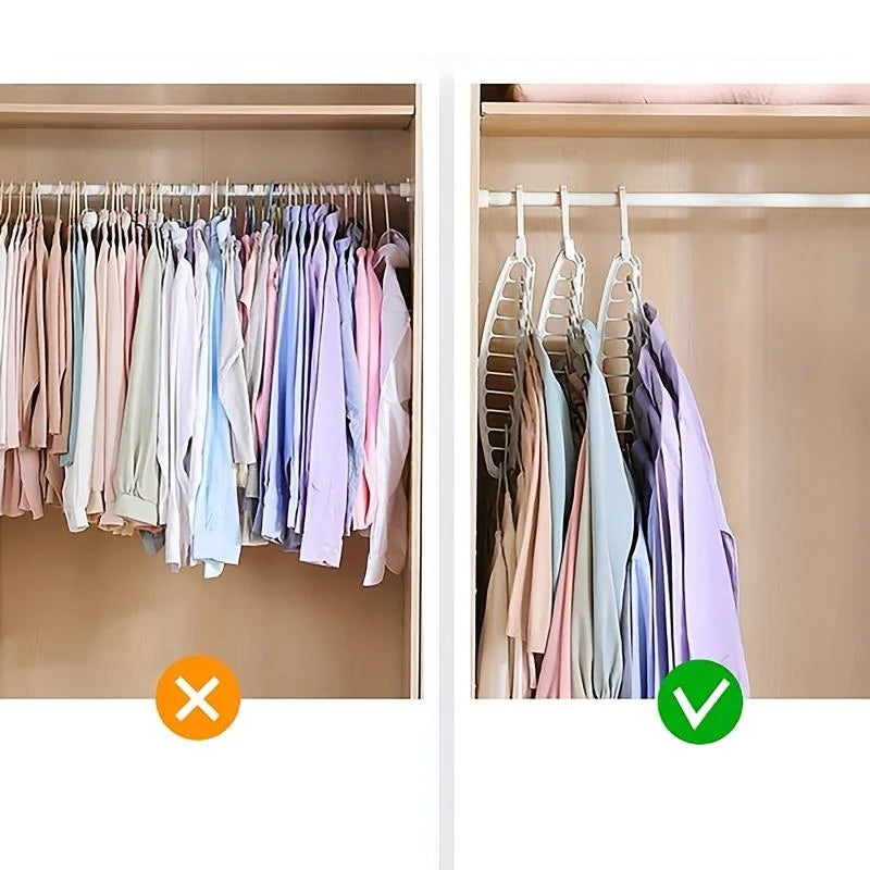 A close-up view of a foldable multi-hole space-saving laundry drying rack with various colored shirts hanging inside.