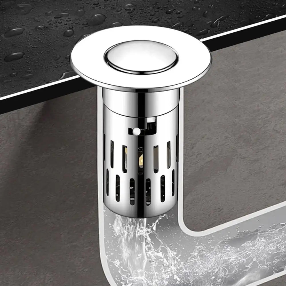 A close-up view of a shiny brass sink drain strainer with a removable metal filter being used to drain water.