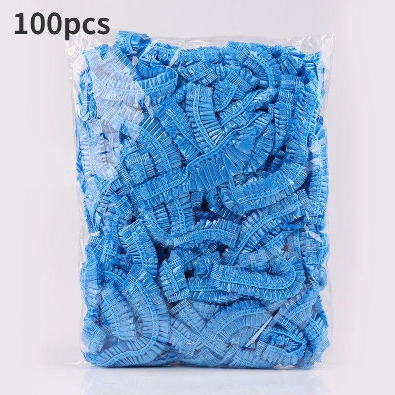 A clear plastic bag filled with 100 blue reusable transparent shower caps.