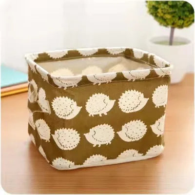 A square storage basket made of cotton and hemp with a olive green background and white textured pattern.
