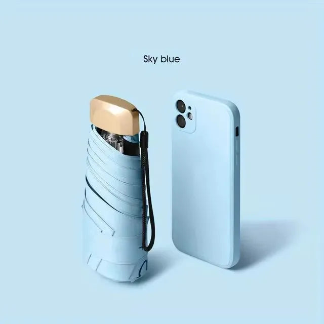 A light blue compact folding umbrella is shown against a pale blue background.