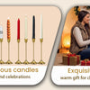 A set of six gold weighted metal taper candlestick holders displayed next to a couple gifting a wrapped present.