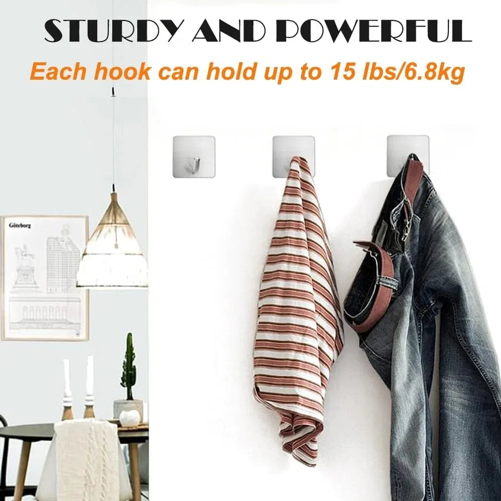 Stainless steel adhesive hooks holding a striped towel and denim jeans on a white wall.
