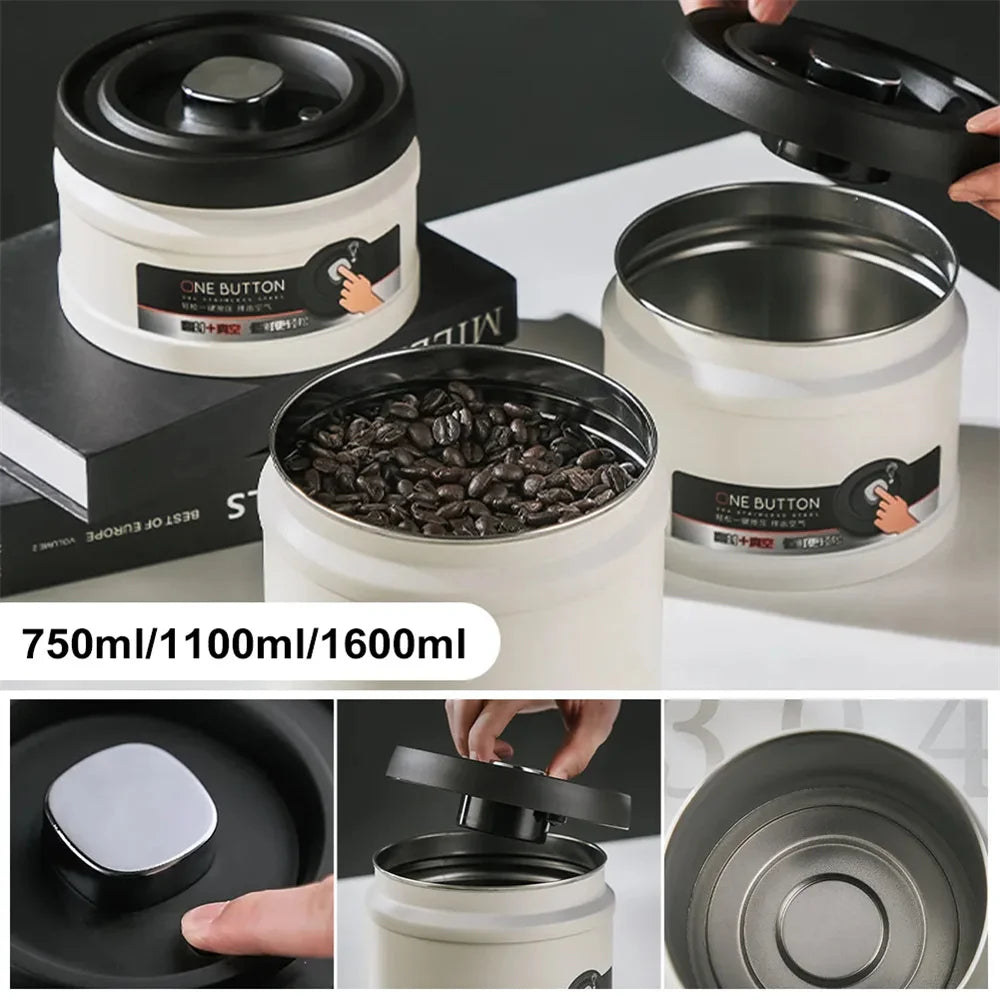 A white stainless steel vacuum sealed storage canister with a black lid and a dark coffee bean inside.