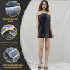 A model wears a dark navy velvet bath towel with gold thread embroidery, highlighting its soft touch and hook design.