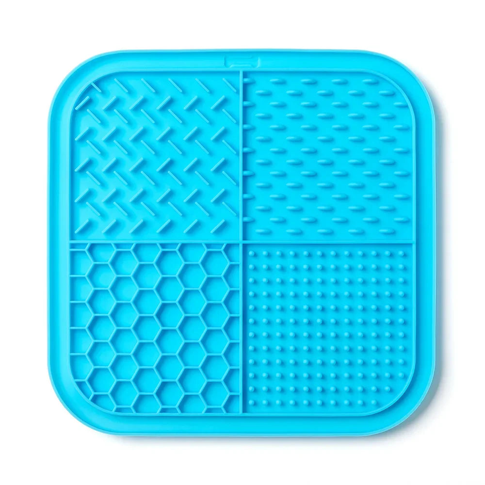 A bright blue silicone lick mat divided into four sections for pets.