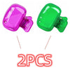 Two protective caps for toothbrush holders, one pink and one green.