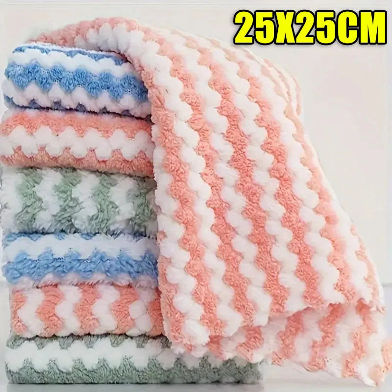 A stack of pink and white coral fleece cleaning cloths with a white and pink checkered pattern.