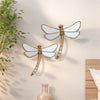 Golden dragonfly mirror wall decor featuring a detailed, ornate dragonfly design.