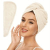 A woman is wearing a beige microfiber hair towel wrap on her head.