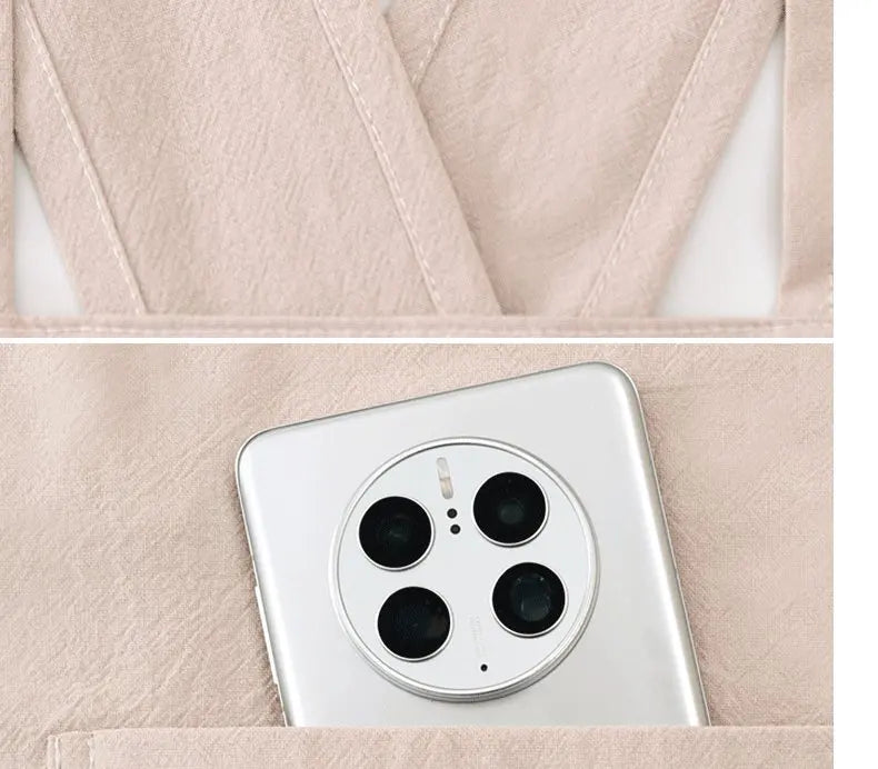 A white smartphone is placed in a light pink fabric pouch or apron pocket.