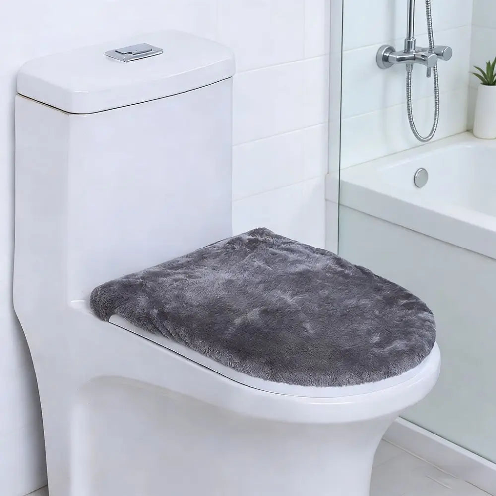 A white toilet features a gray protective seat cover placed on the seat.