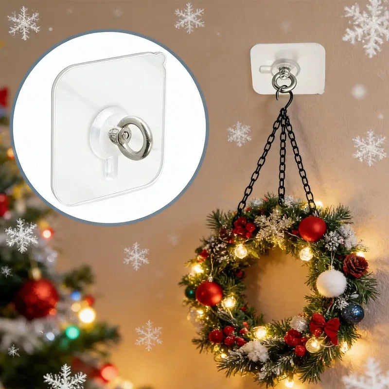 A close-up of a clear self-adhesive stainless steel wall hook and a finished wreath decorated with lights and ornaments.