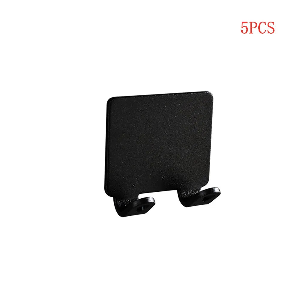 A black aluminum shaving razor storage rack with mounting brackets.
