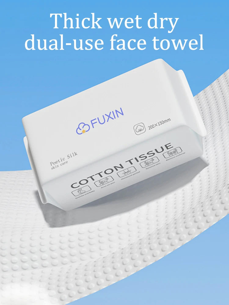 A white Fuxin thick wet dry dual-use cotton tissue face towel is shown resting on a white textured cloth.