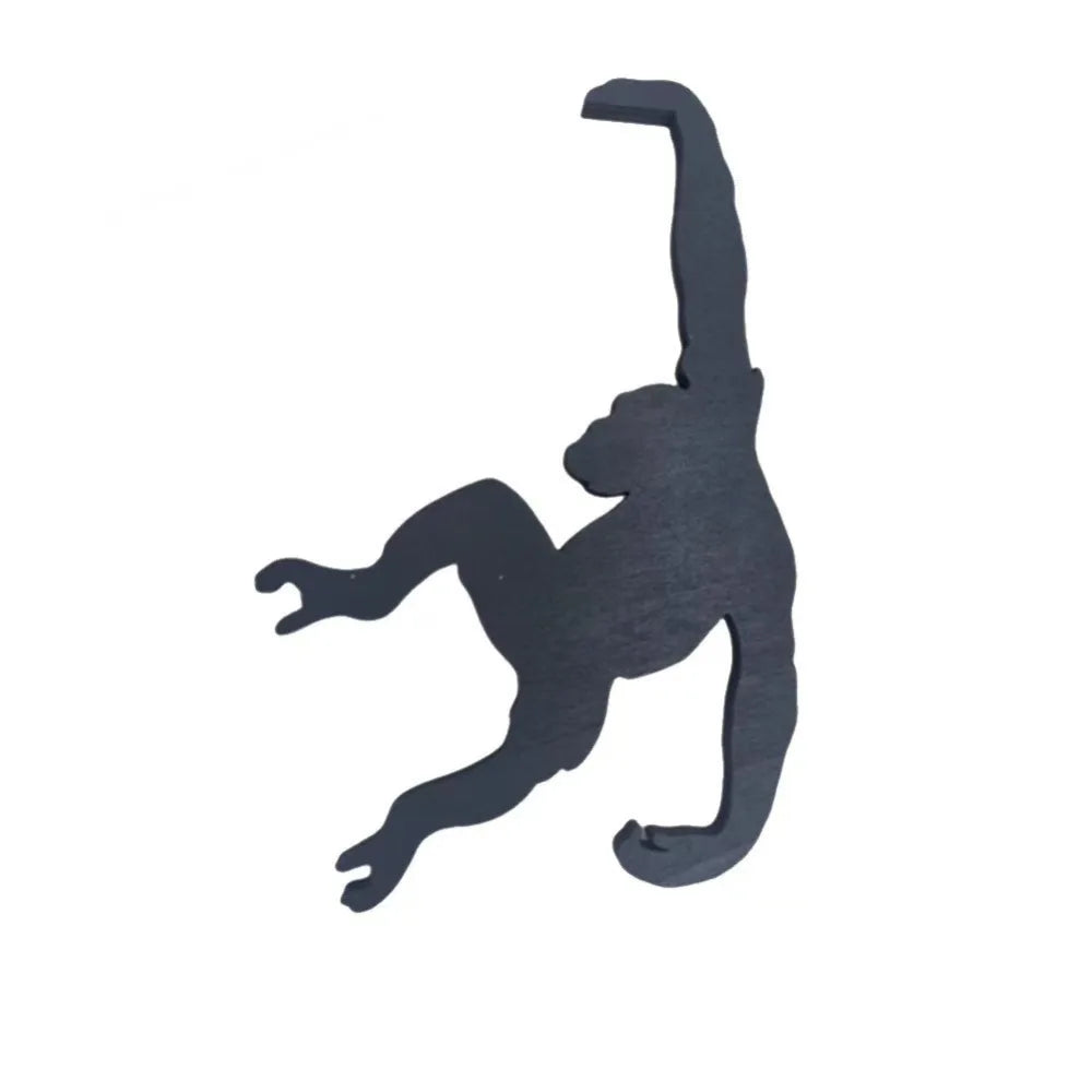 A black monkey-shaped wooden key hanger decoration.