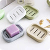 A collection of double layer drain soap dishes in various colors and materials, including white, green, and beige.
