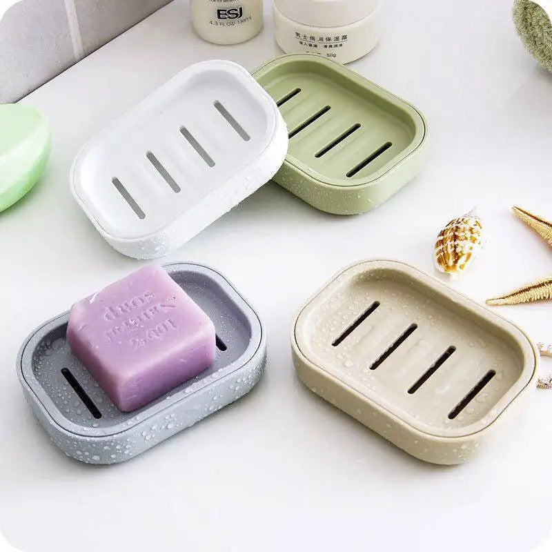 A collection of double layer drain soap dishes in various colors and materials, including white, green, and beige.