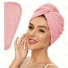A woman is wearing a pink microfiber hair towel wrap on her head.