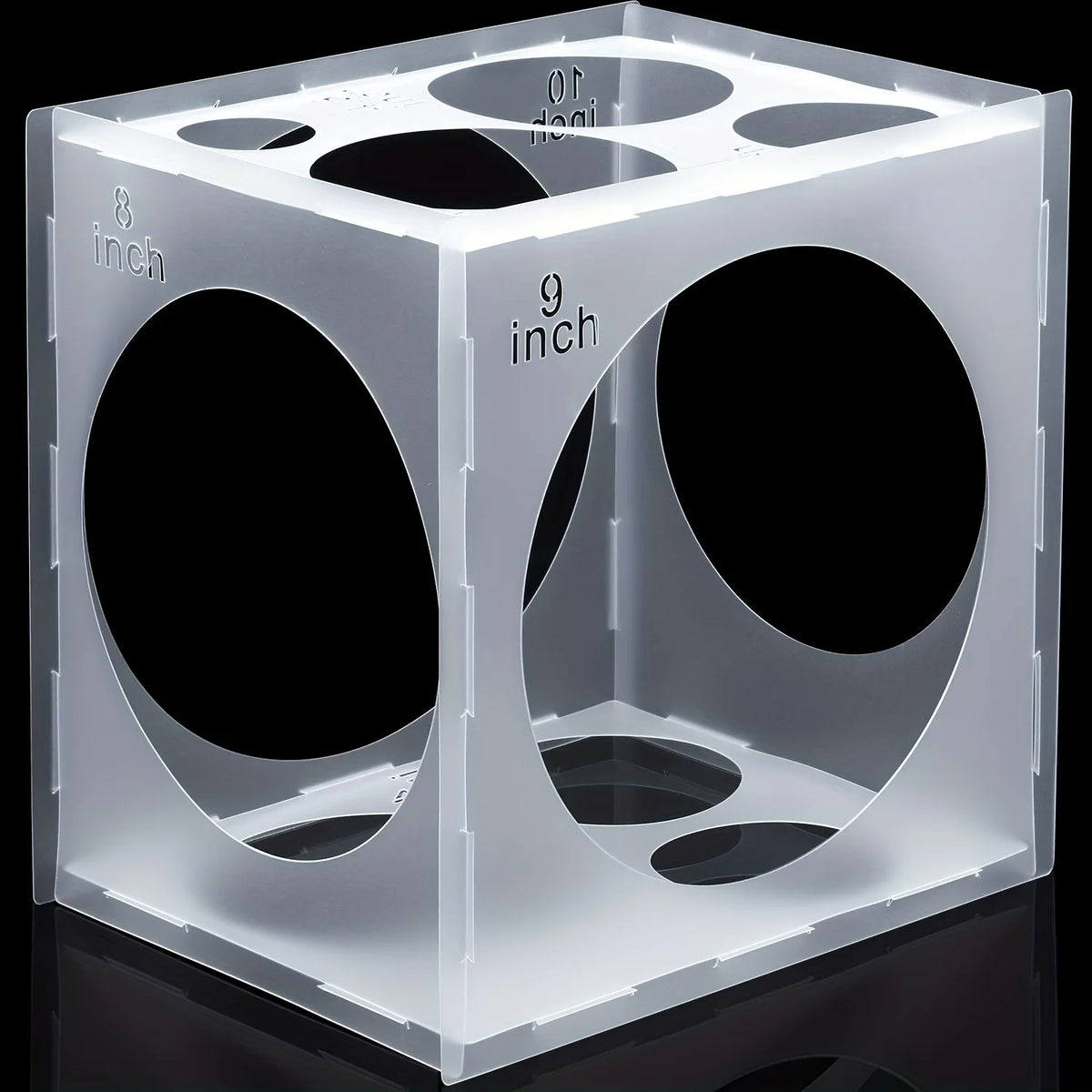 A clear plastic cube with eight circular openings marked with inch measurements, used as a balloon sizer.