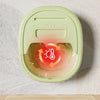 A light green portable foot soak tub with a sauna effect feature is shown on a white surface.