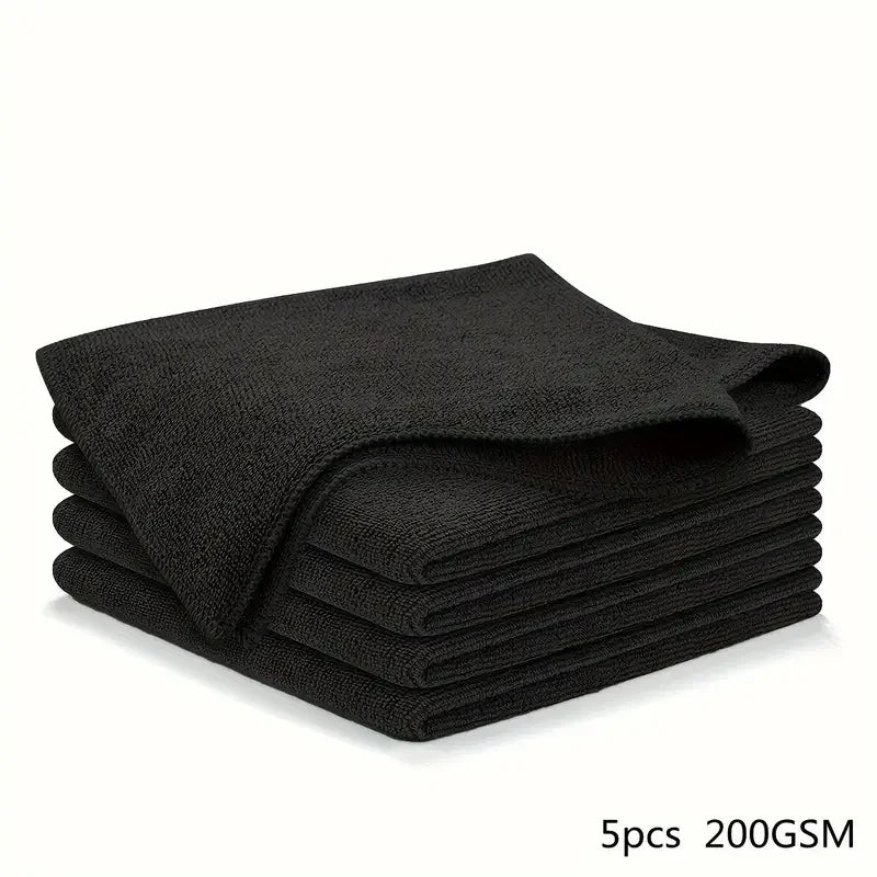 A stack of five black reusable microfiber cleaning cloths.