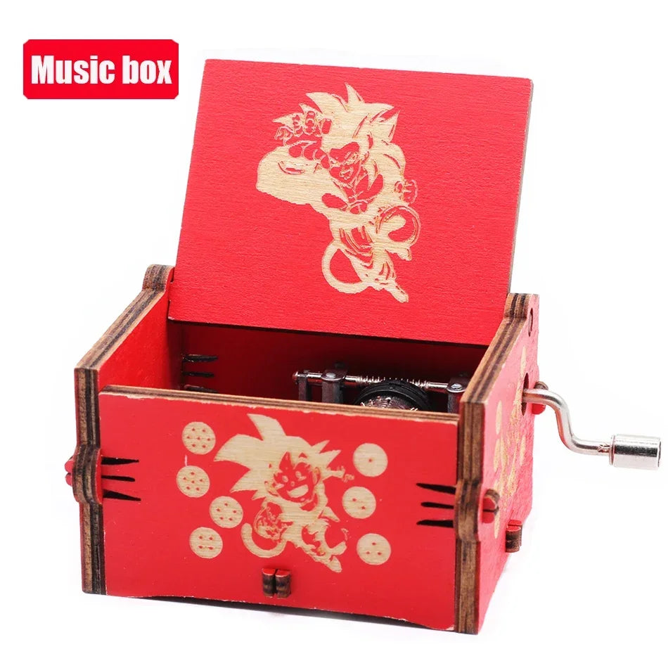 A red wooden music box with an open lid featuring a gold-colored decorative design and a hand crank mechanism.