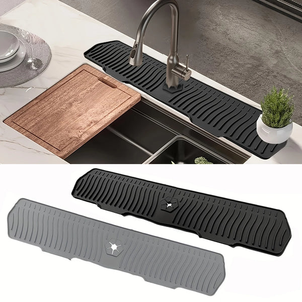 Black silicone kitchen sink drain mat with ribbed texture shown in use over a stainless steel sink.